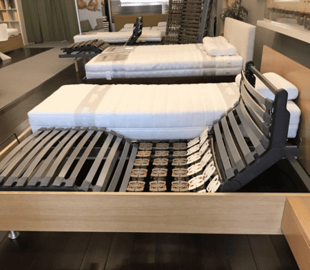 Modern adjustable bed base with a sturdy frame and motorized head and foot adjustments, ideal for enhancing sleep comfort and support.