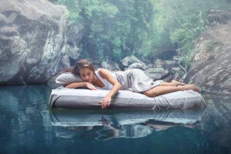Soft, comfortable mattress floating on water in nature, promoting restful sleep, relaxation, and mattress shopping tips in the context of The Mattress Underground.